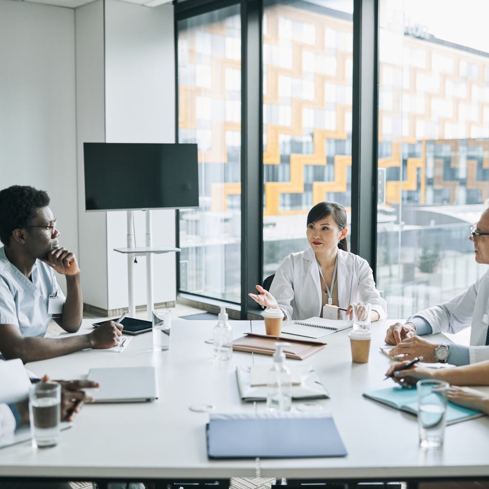 Healthcare leaders reviewing data together in a hospital meeting
